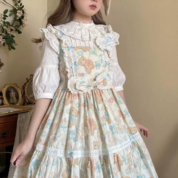 Pale beige blouse & top on a hanger with a high stand collar, layered lace trim, pleated bib and gathered sleeves.