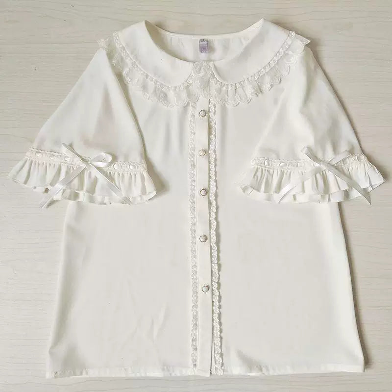 White short-sleeve blouse with a rounded lace collar and ribbon-tied ruffles
