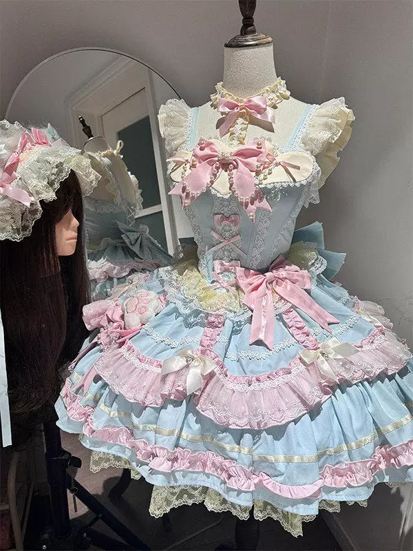 Blue and pink layered JSK dress with bows and a train displayed on a dress form.