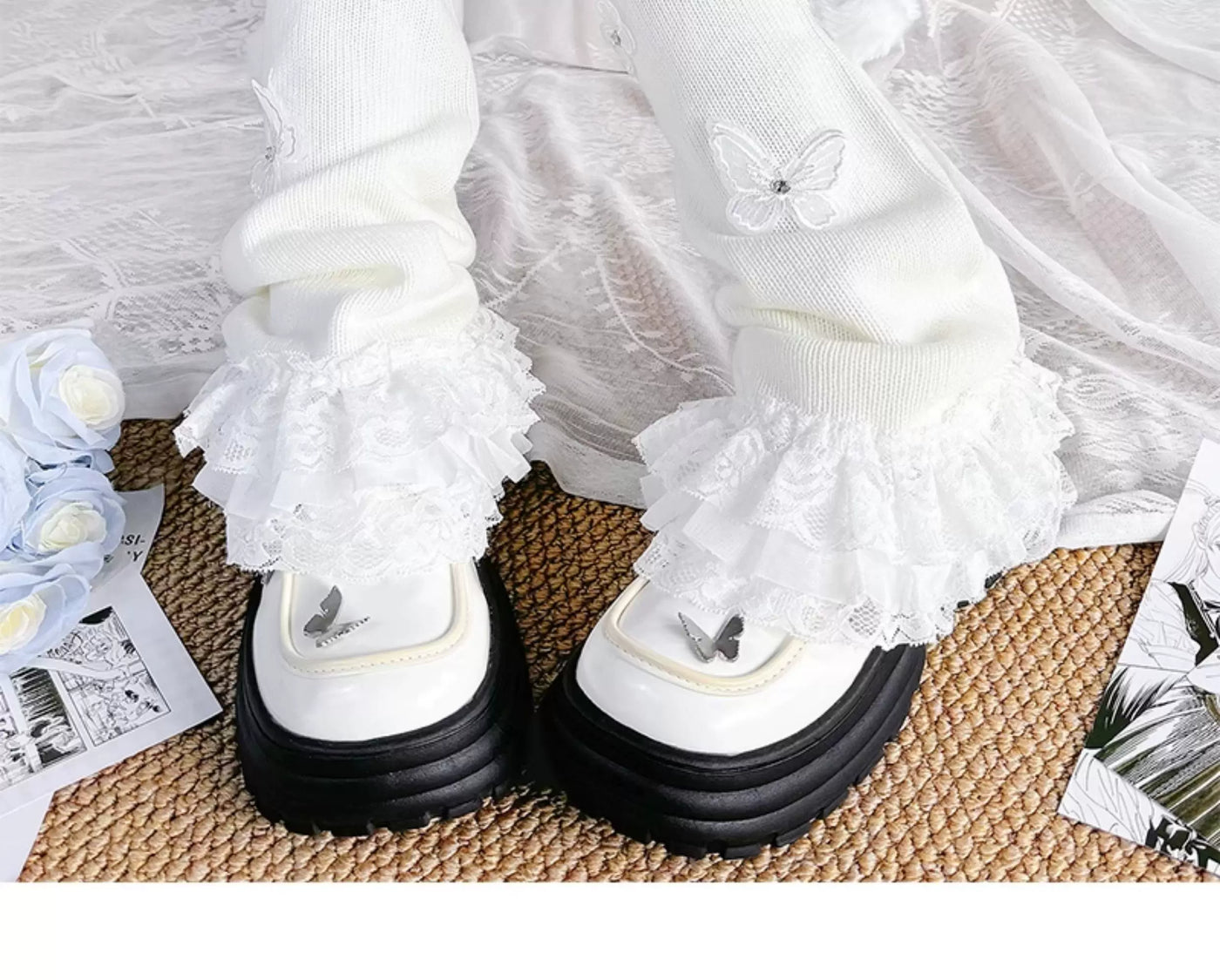 White knit leg warmers with lace ruffles, butterfly details, ribbons and pom-poms