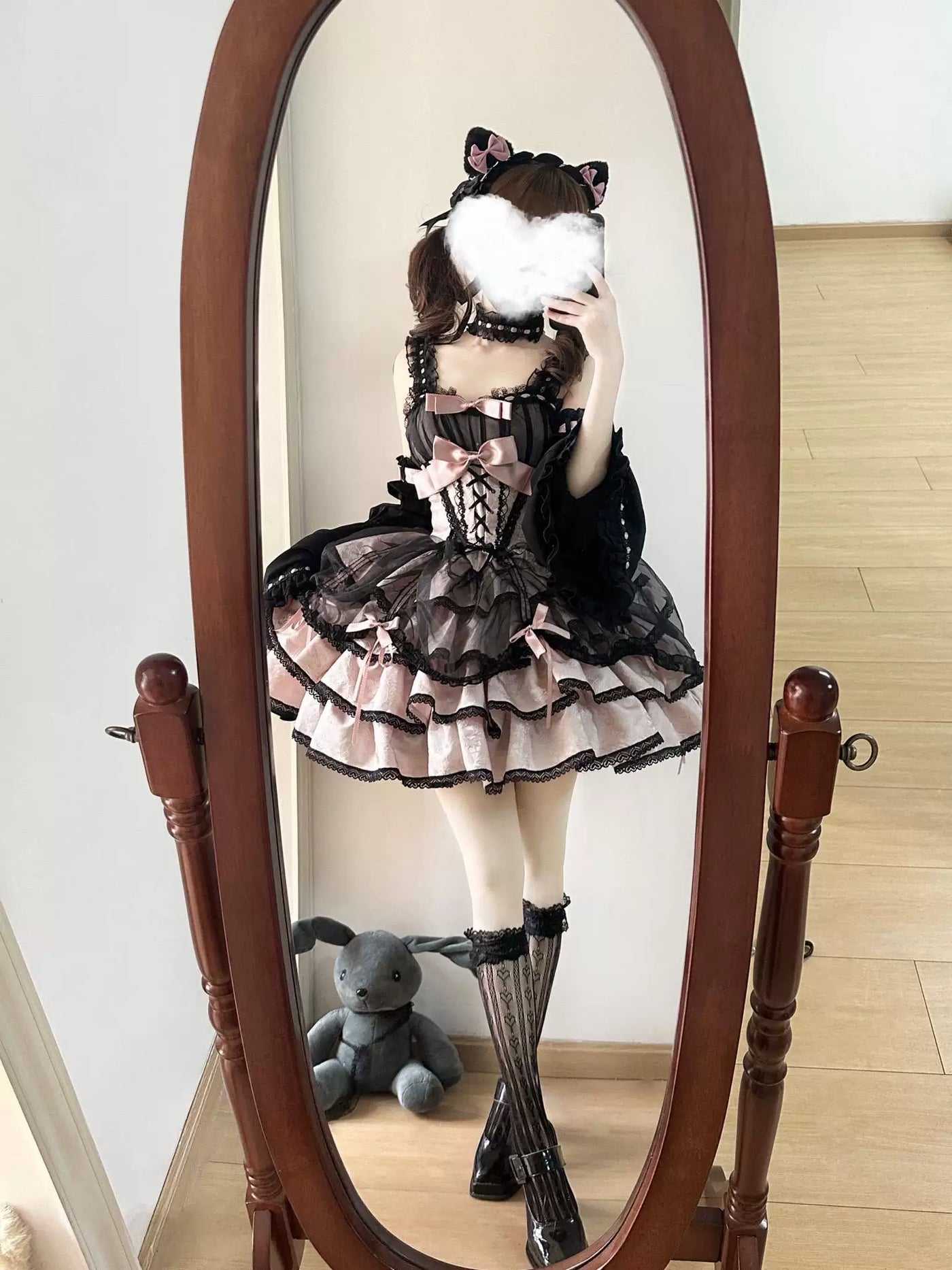 Mirror view of a model wearing a Creamy black-and-pink JSK dress with arm sleeves