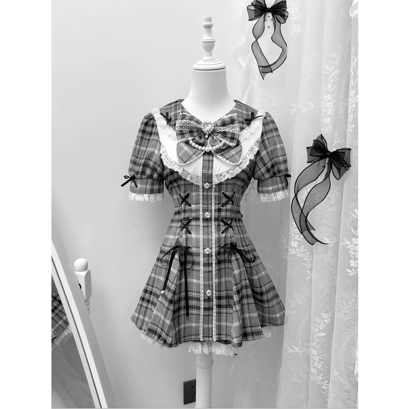 Detail of corset-style ribbon lacing and silver-toned buttons on the gothic lolita dress bodice