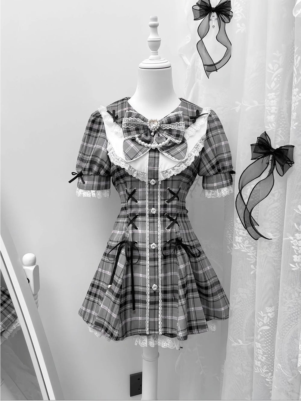 Front view of gray gothic lolita three-piece dress set with plaid pattern, lace trim, and bow accent