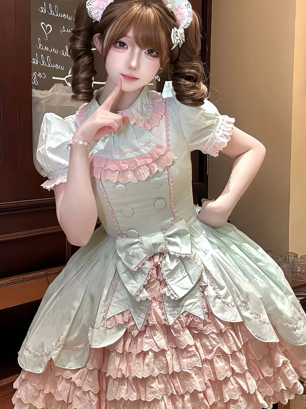 Model wearing a pink-and-mint layered short-sleeve OP dress with bow and ruffle details.