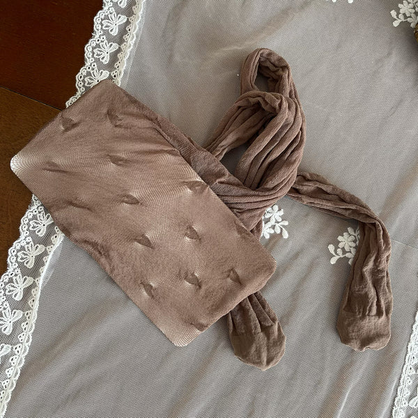 Khaki heart-pattern pantyhose with lace panels and ruffled trims styled with cream shoes.