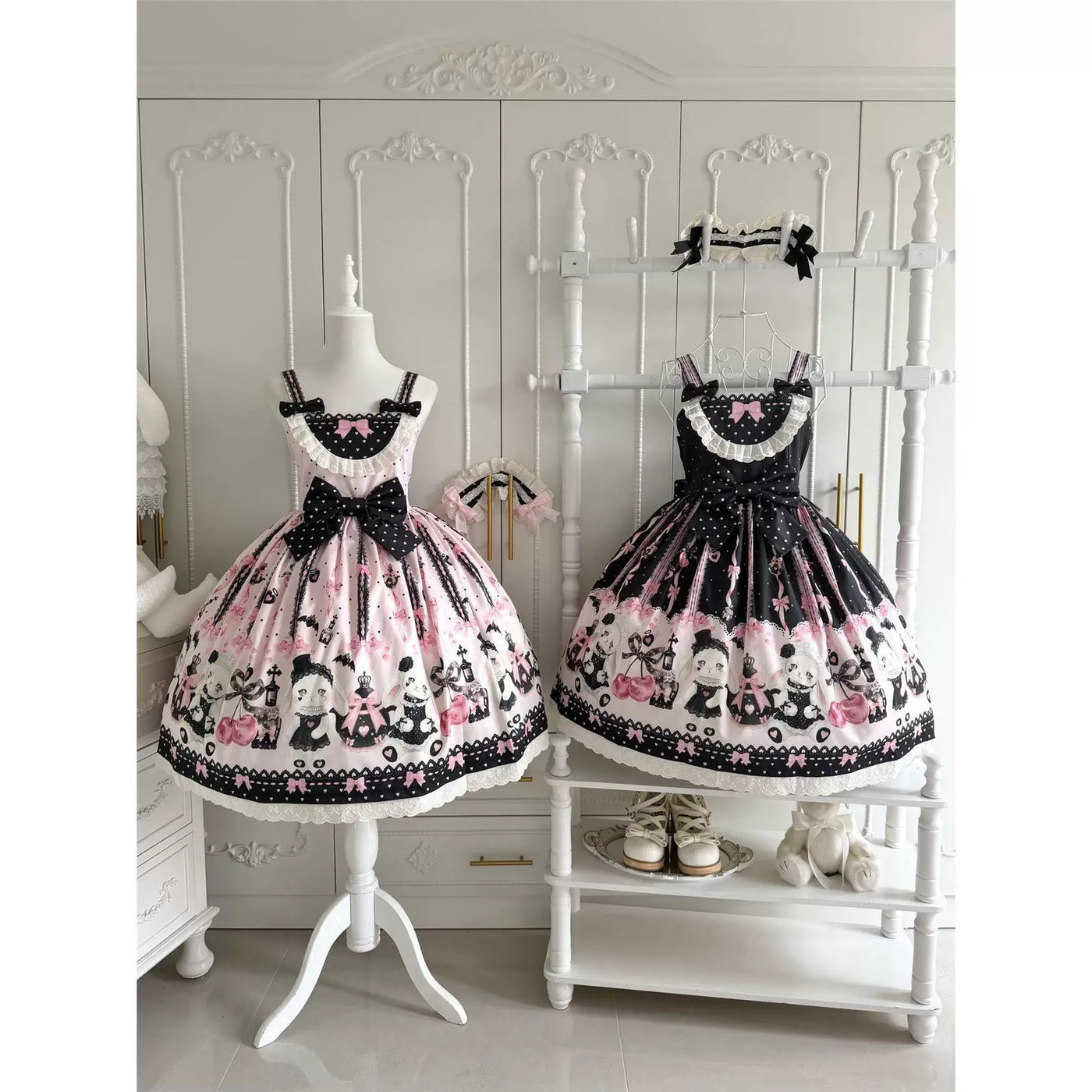 Pink and black heart-print JSK dresses with bows displayed on mannequins.