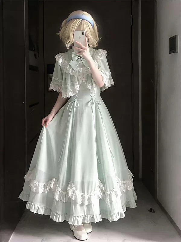 Apple-green OP dress with a lace cape overlay and layered ruffle hem