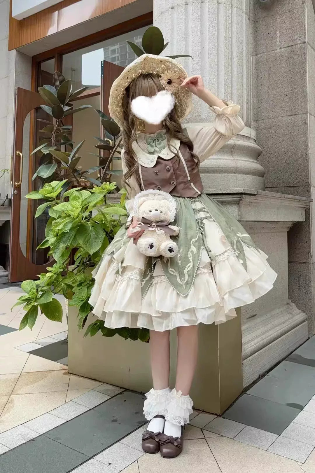 Green and cream three-piece outfit with a vest, shirt and gathered short skirt
