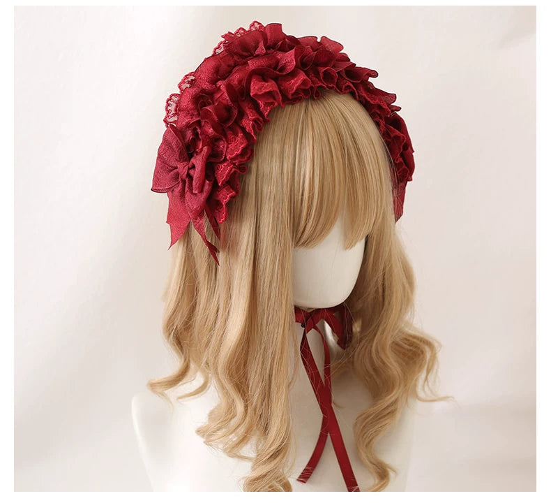 Ruffled lace headband in burgundy and black shown on mannequin wigs.