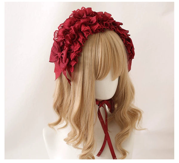 Ruffled lace headband in burgundy and black shown on mannequin wigs.