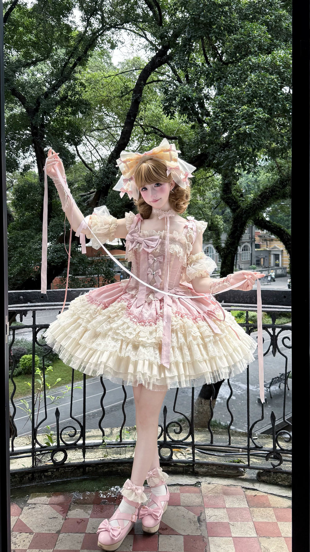 Blue-and-white floral JSK dress with layered lace tiers, bows and a decorative headpiece worn by a model.