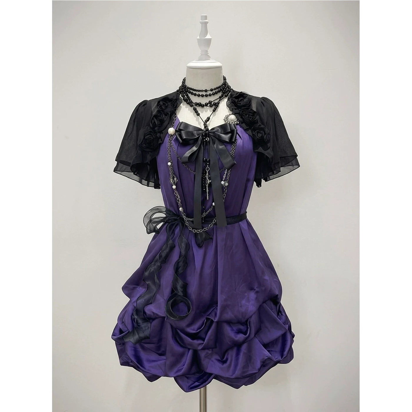 Styled image of a purple OP with a black rose cardigan and layered ruffles.