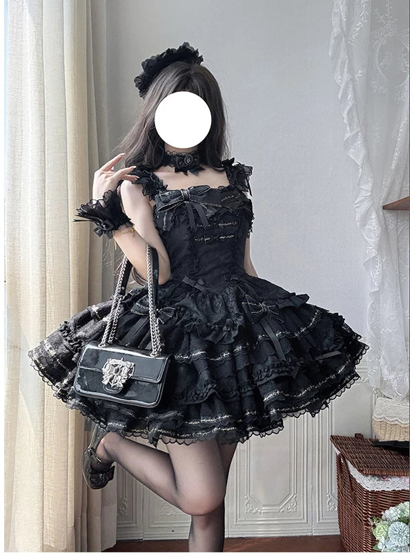 Black layered one-piece dress with lace ruffles and bows on a model