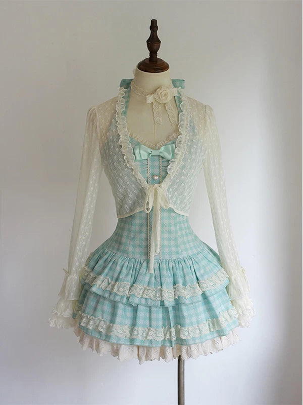 Blue-and-white gingham dress with sheer cardigan displayed on a mannequin