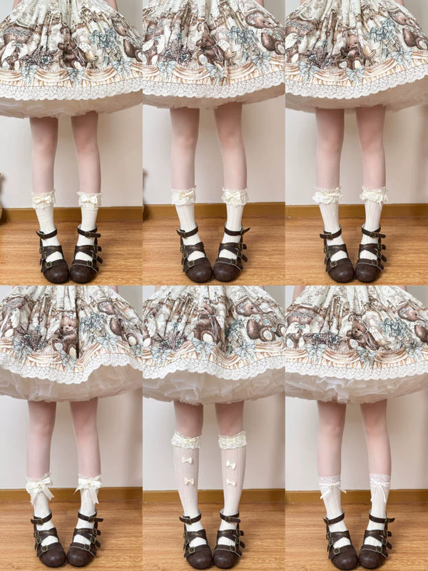 Chubby Bear Tales cream-yellow lace socks with bow trims styled beneath a printed skirt.
