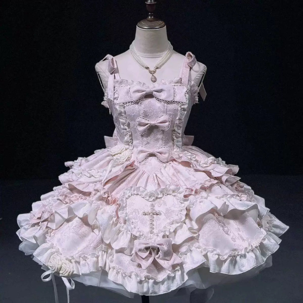 Pale blue JSK with layered ruffles, bows, heart panel and rose details displayed on a mannequin.