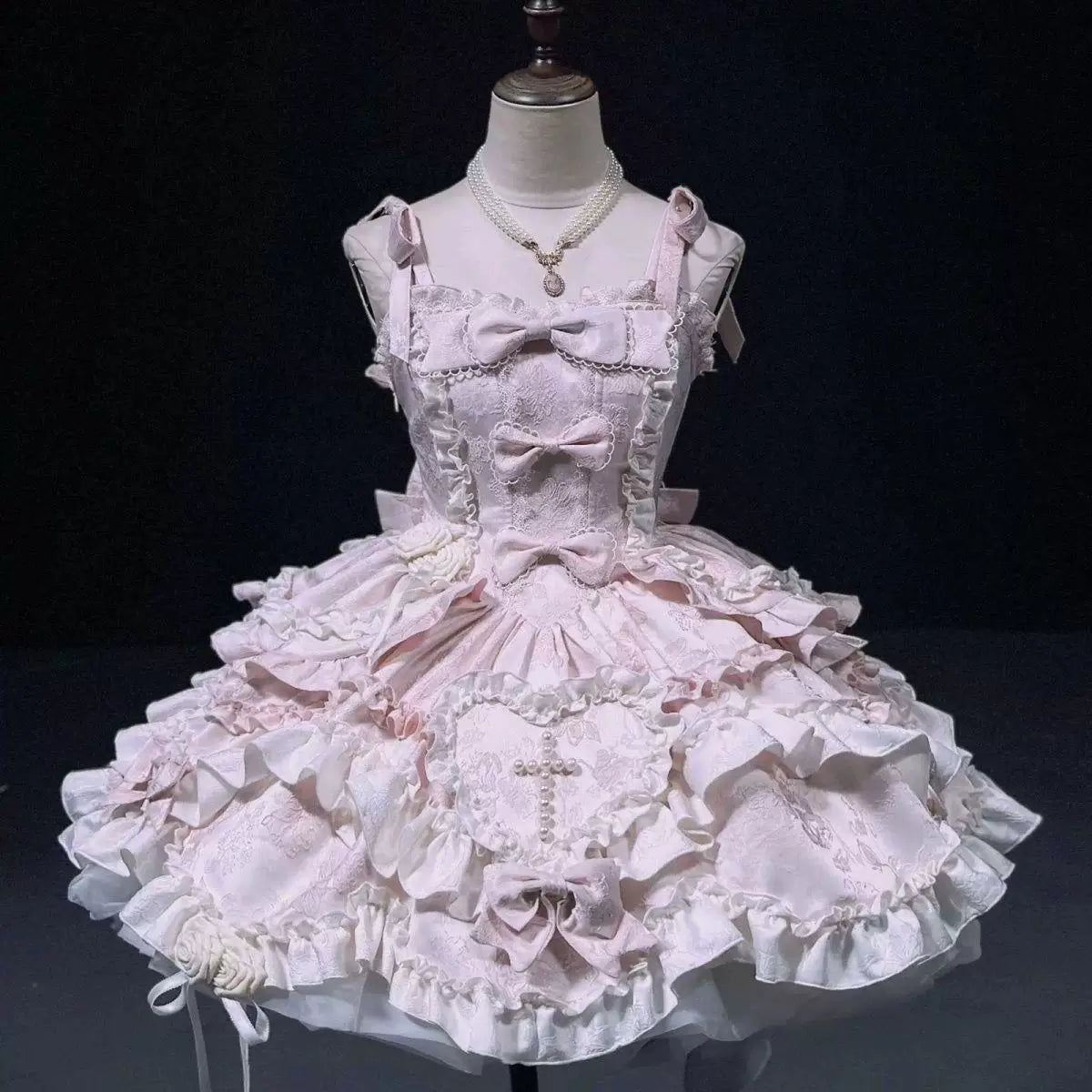 Pale blue JSK with layered ruffles, bows, heart panel and rose details displayed on a mannequin.