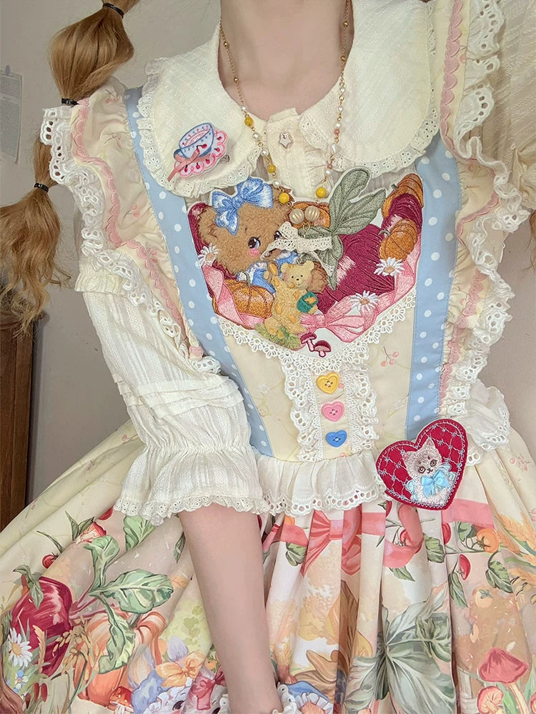 Two models wearing rabbit and carrot print Lolita dresses with pale blue borders and lace hems
