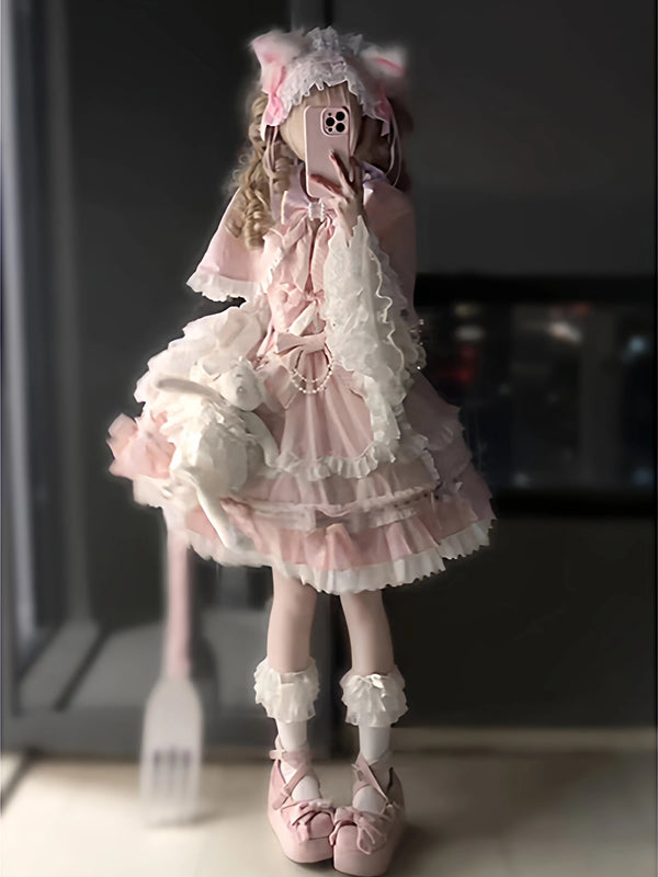 Pink-and-white Lolita outfit with lace cape, suspender dress and hime sleeves