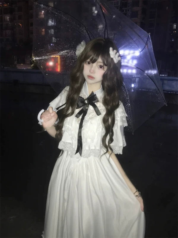 White short-sleeve OP dress with a dark ribbon bow shown front and back.