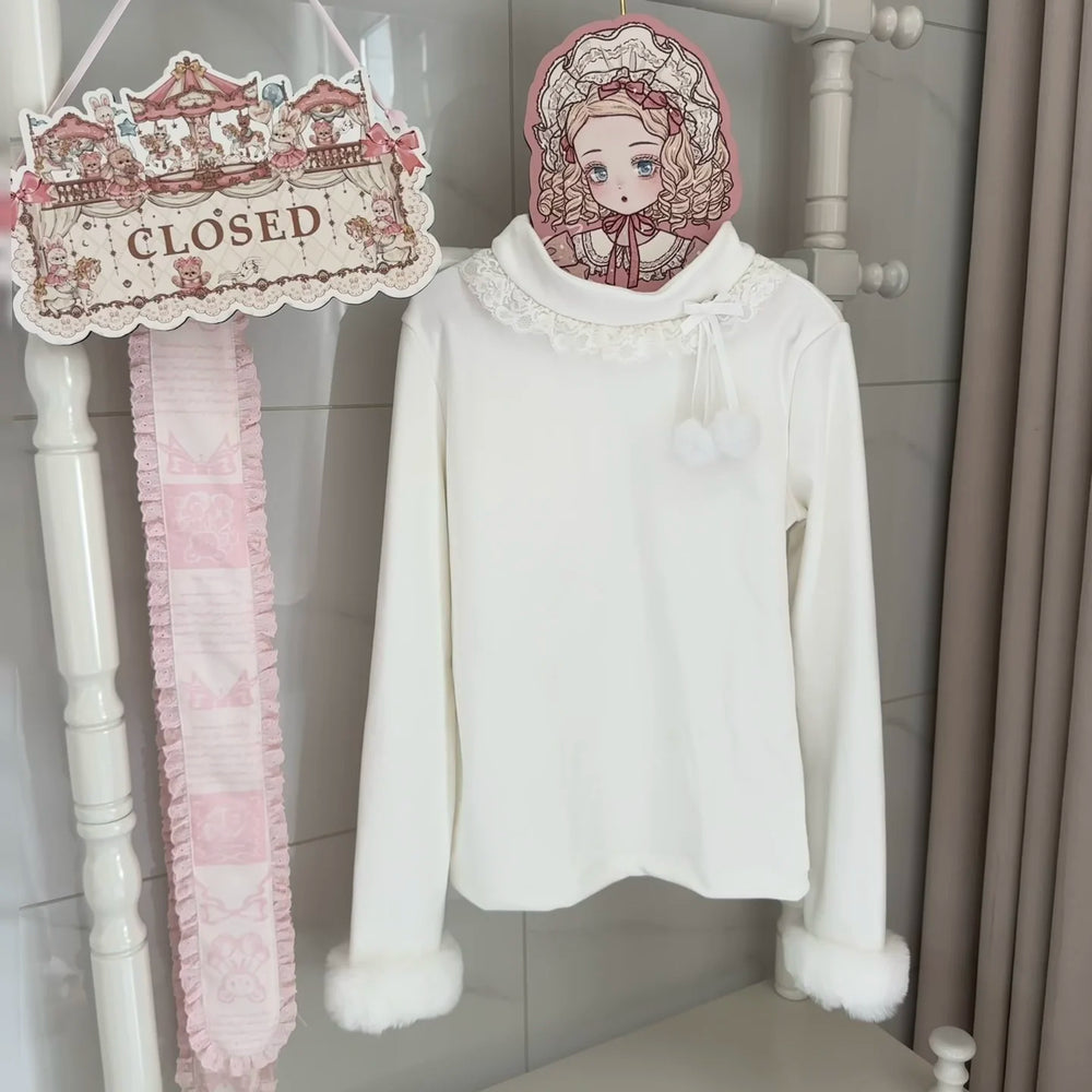 White long-sleeve inner top with lace collar and fuzzy cuffs displayed against a decorative backdrop