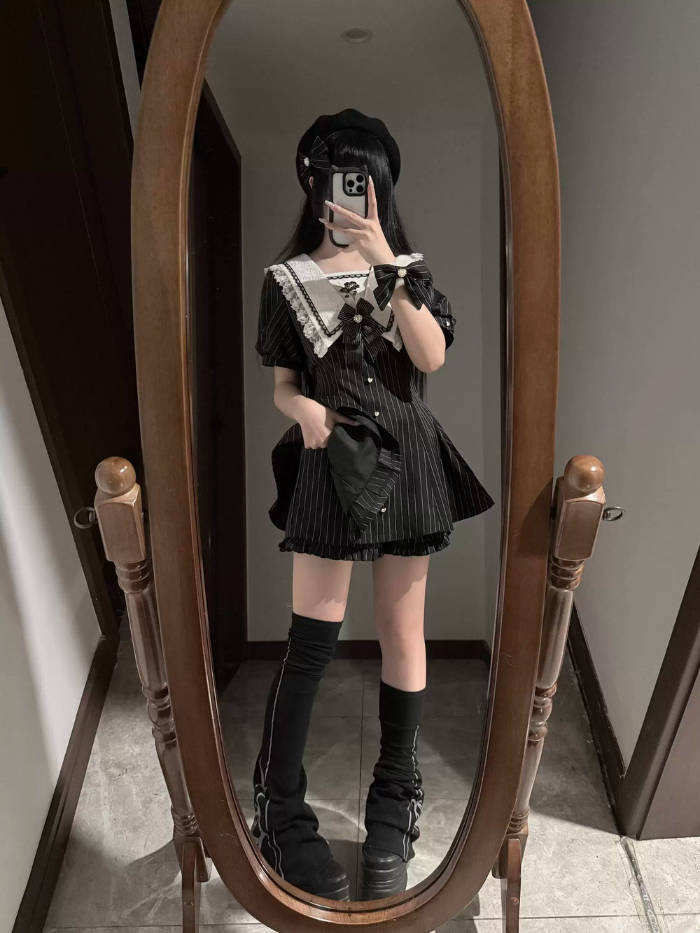 Black pinstripe OP dress and shorts set with a white lace collar shown on a model.