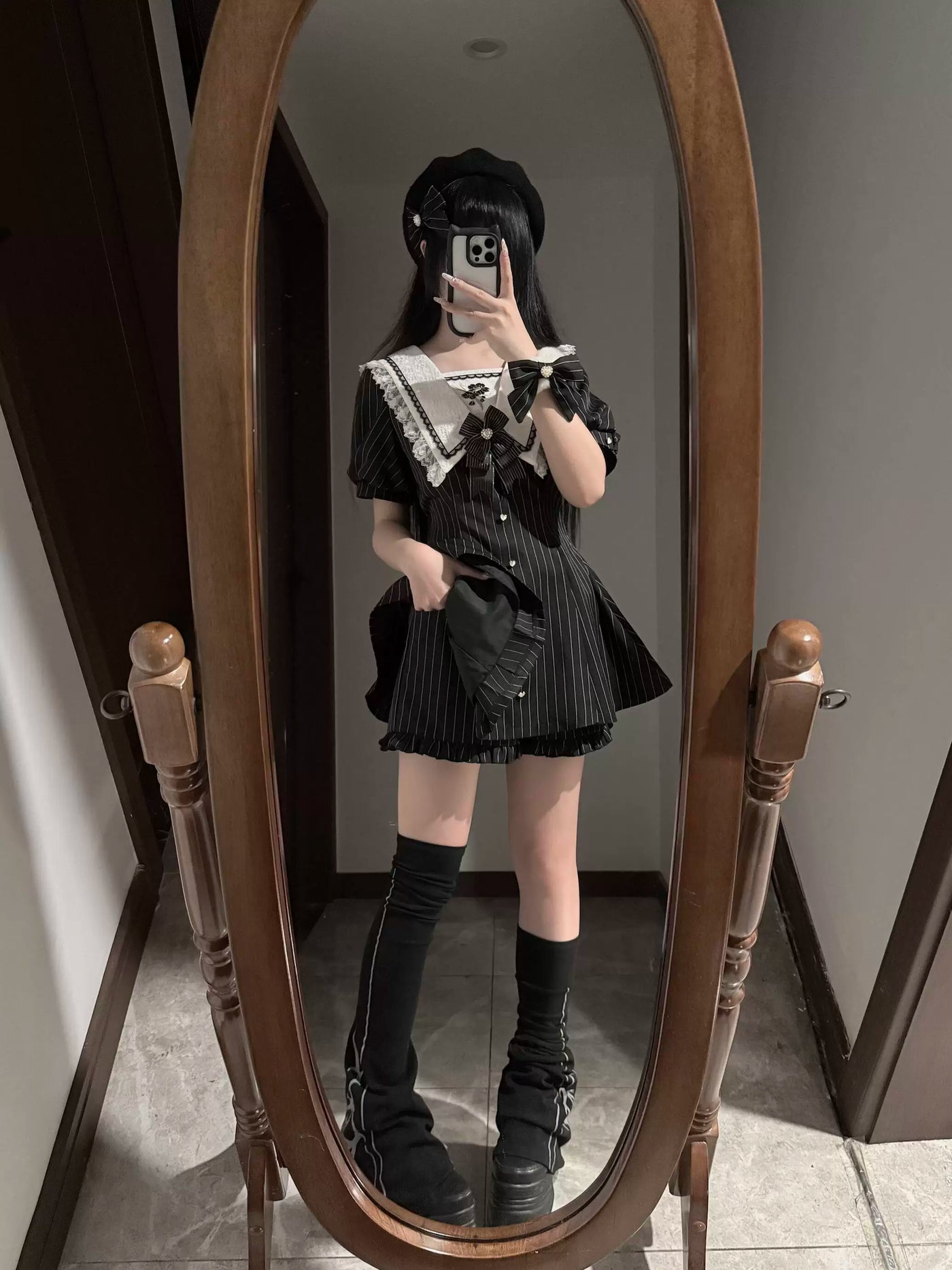 Black pinstripe OP dress and shorts set with a white lace collar shown on a model.