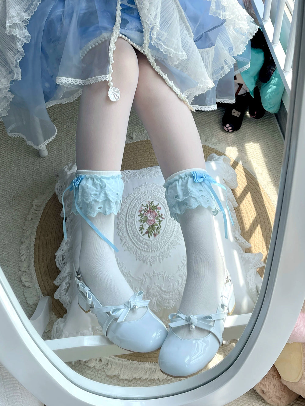 White and blue mid-calf socks with ruffled lace cuffs and blue bows