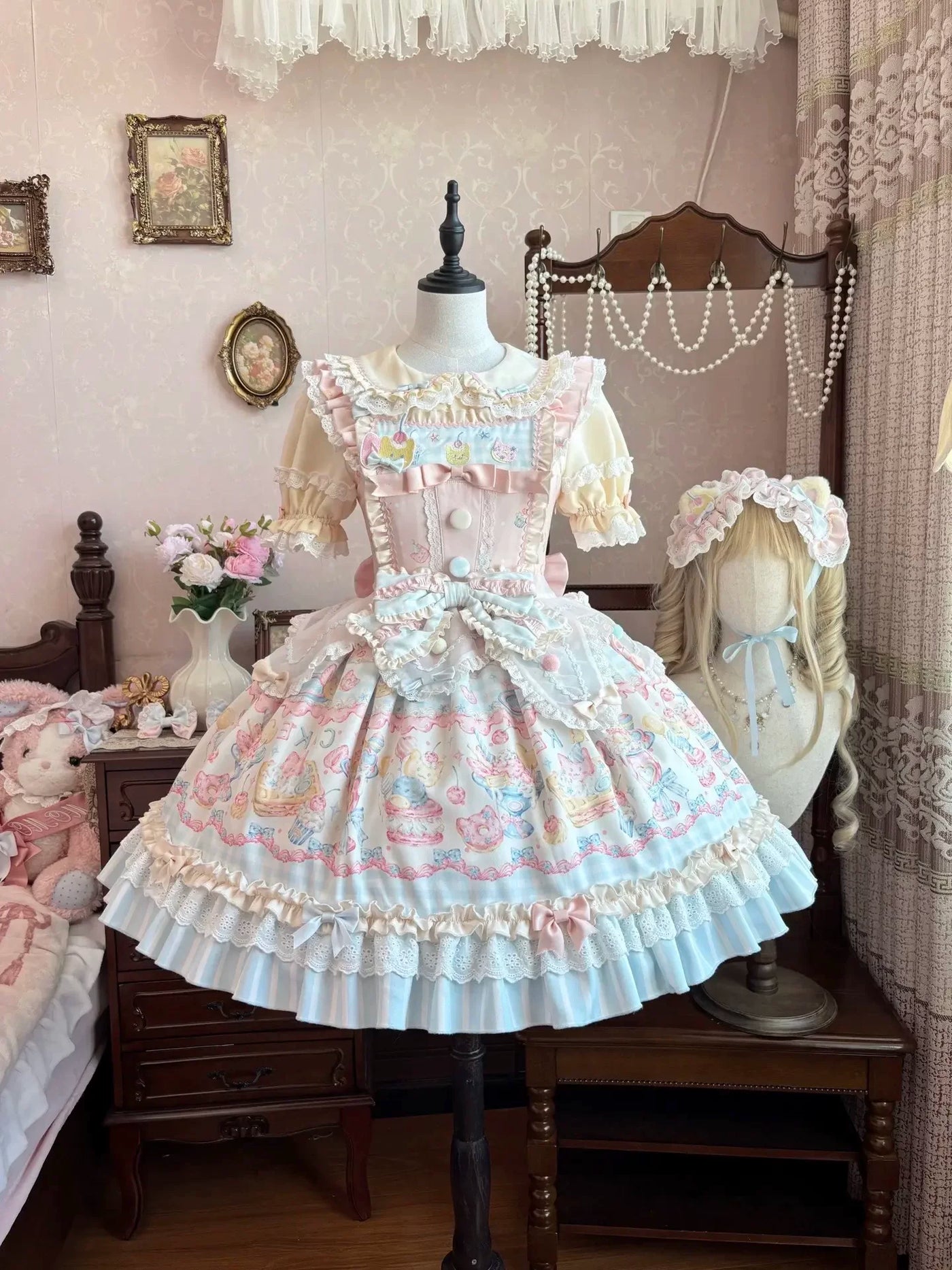 Detail view of the dress's Peter Pan collar, lace trim, and pearl-like front buttons