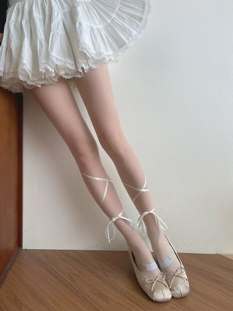 Beige sheer stockings with satin ribbon ties around the ankles.