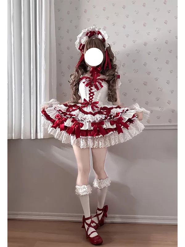 Red and white frilled JSK dress with a trailing hem worn in two indoor views; face is obscured.