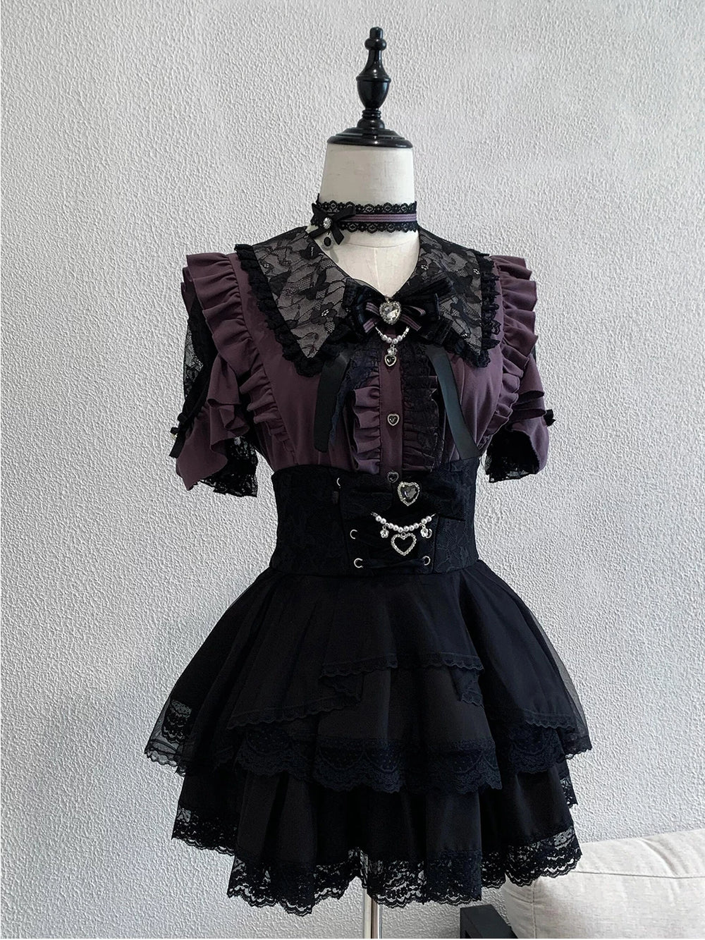 Purple and black Lolita blouse and high-waisted skirt set on a mannequin