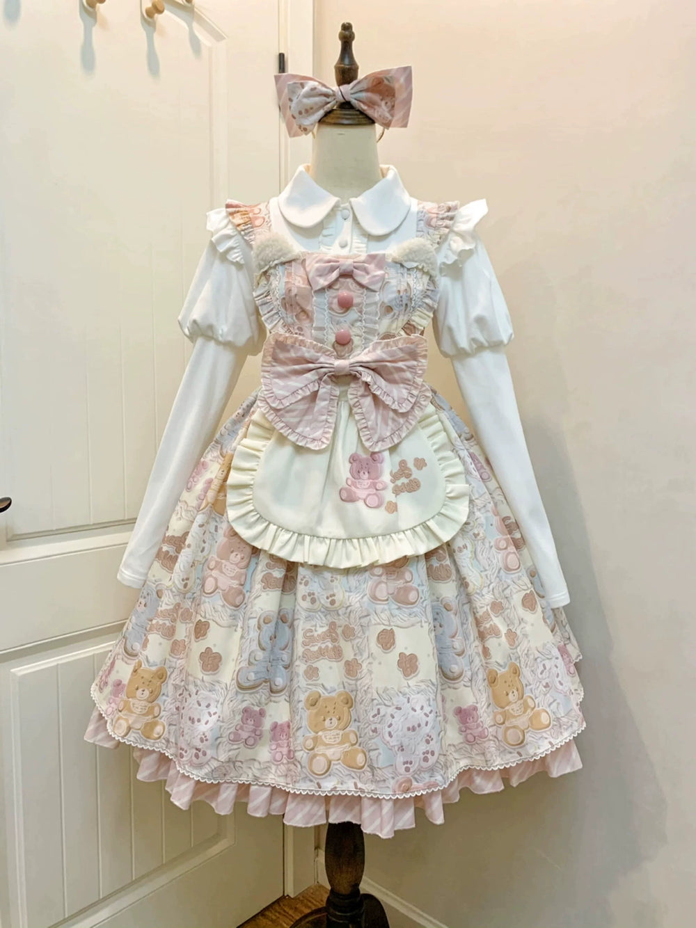 Pastel teddy-bear print JSK with a ruffled apron and pink bow.