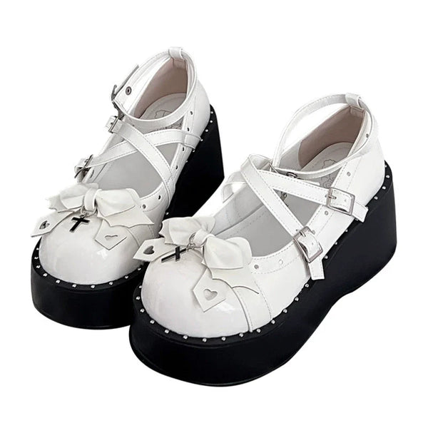 White and black punk Lolita platform shoes with bows, cross charms and buckled straps