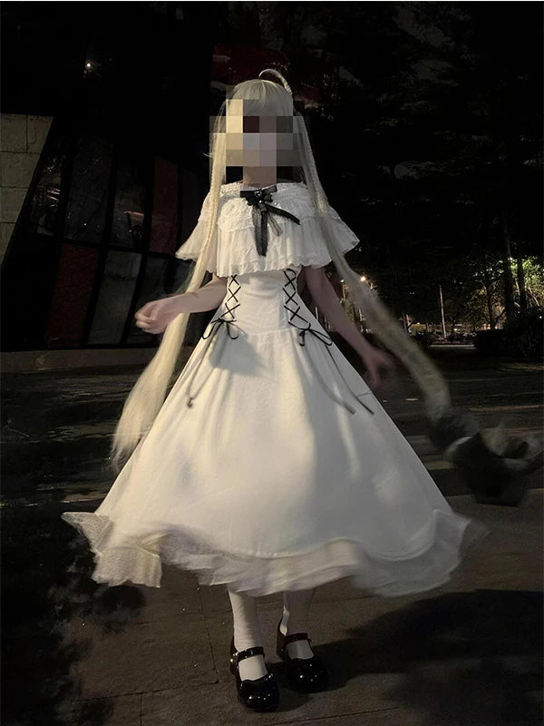 White Lolita dress with black waist ties and a full skirt shown outdoors at night.