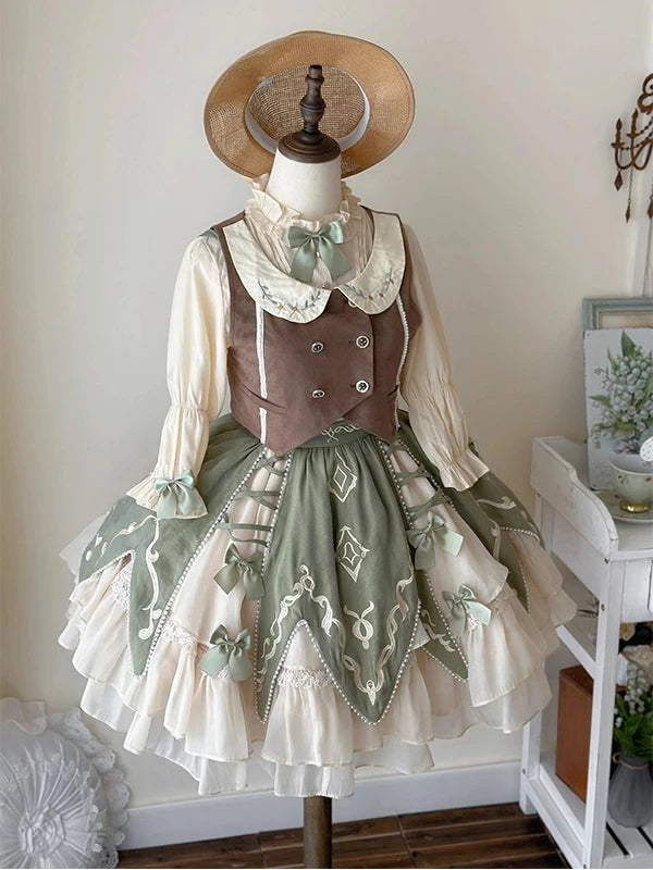 Creamy sage-green, cream and brown vest, shirt and short skirt set on a mannequin.
