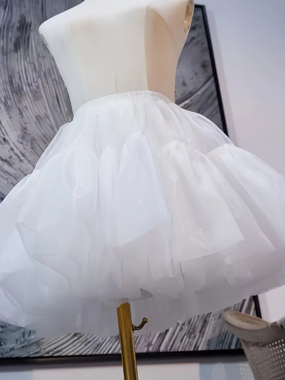 White tulle petticoat shown on a mannequin with a rounded skirt shape.