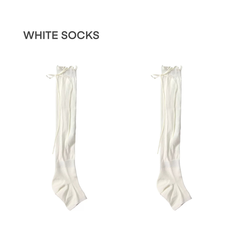 A pair of grey slouchy calf socks with side ribbon ties displayed on a white background.