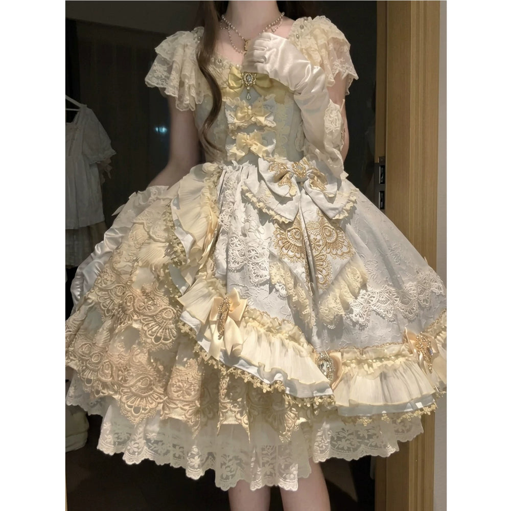 Cream-and-ivory Lolita skirt set with lace layers, bows, veil, and full petticoat.