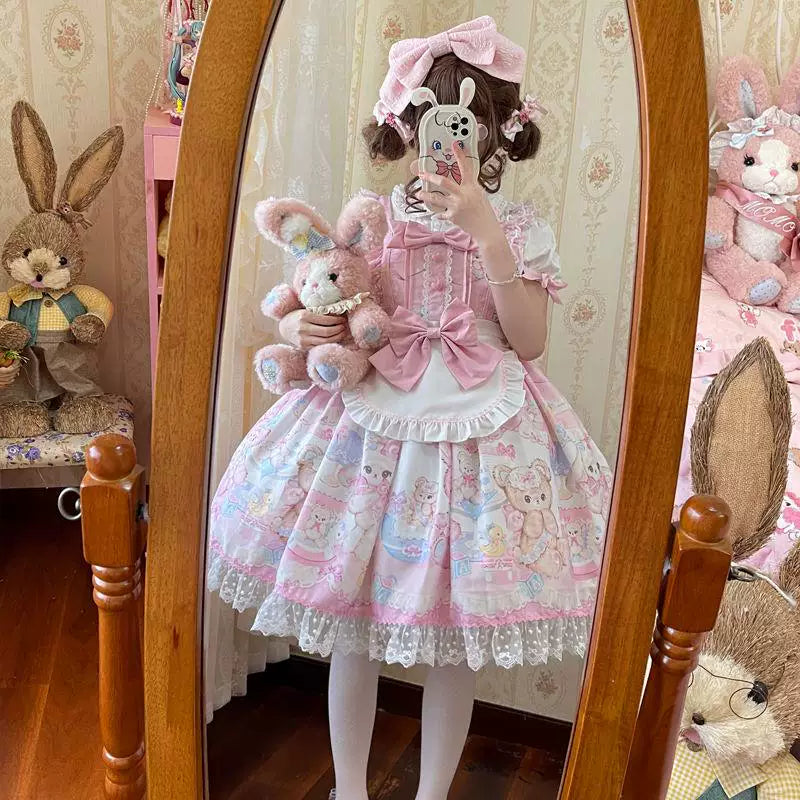 Pastel rabbit-and-bear print JSK with a large bow and white ruffled bib.