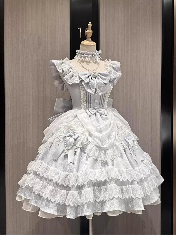 Blue and white ruffled Lolita dress with a large back bow and train shown front and back on mannequins.