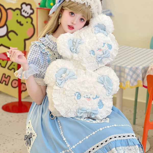 White plush bear backpack with pale-blue bows and lace edging