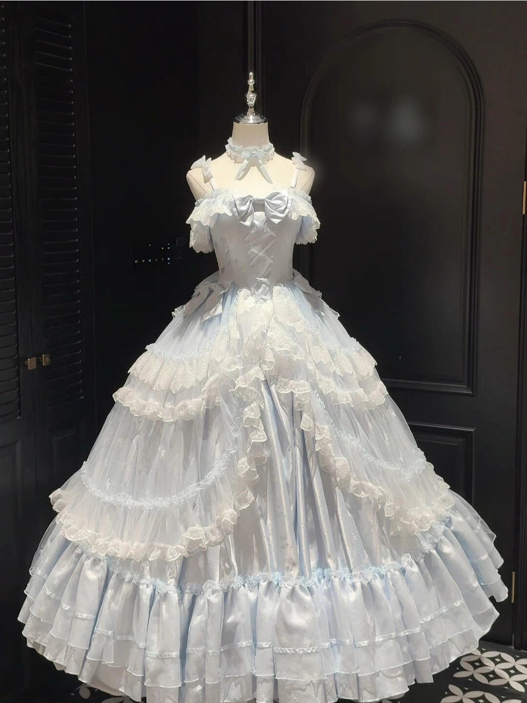 Blue Creamy long Lolita dress with tiered lace ruffles on a mannequin.