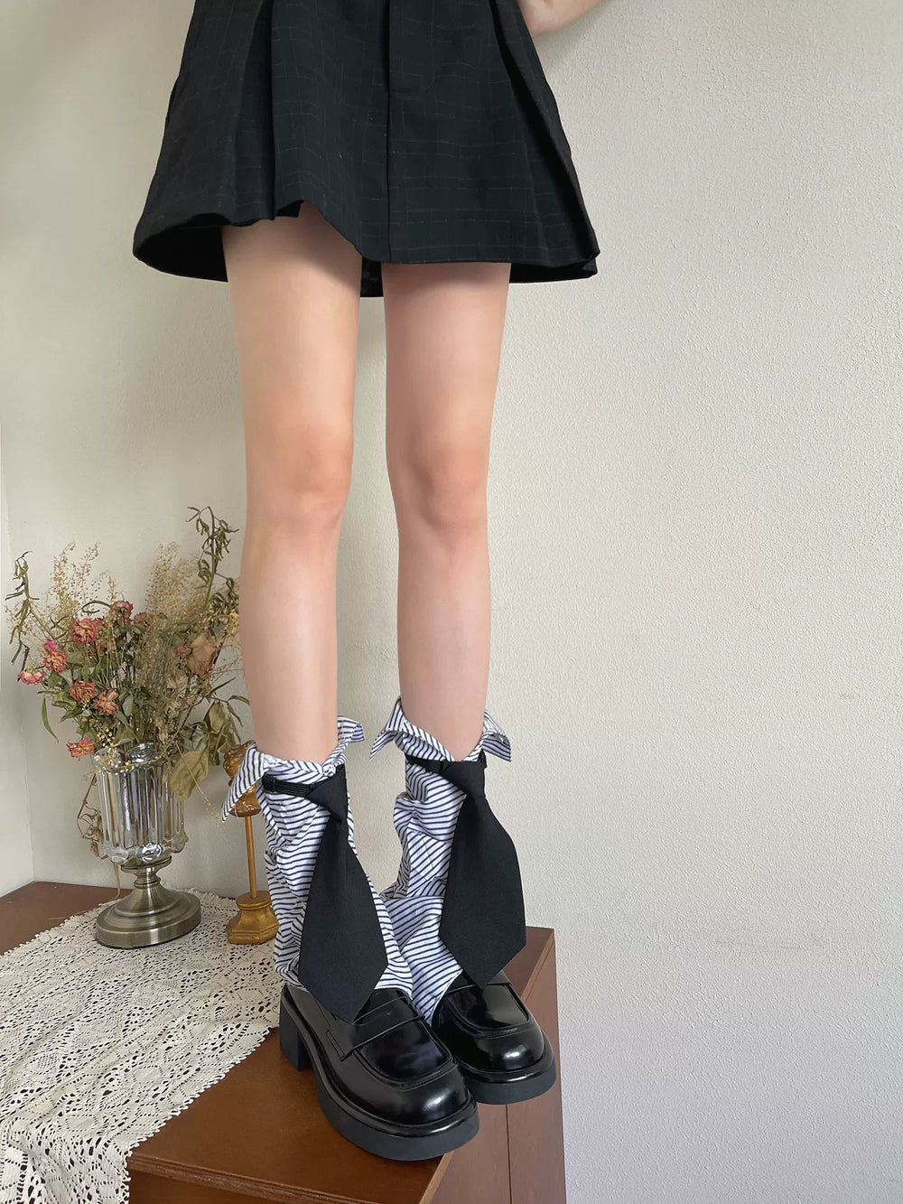 Sock Noble blue-and-white striped sock covers with oversized black tie accents