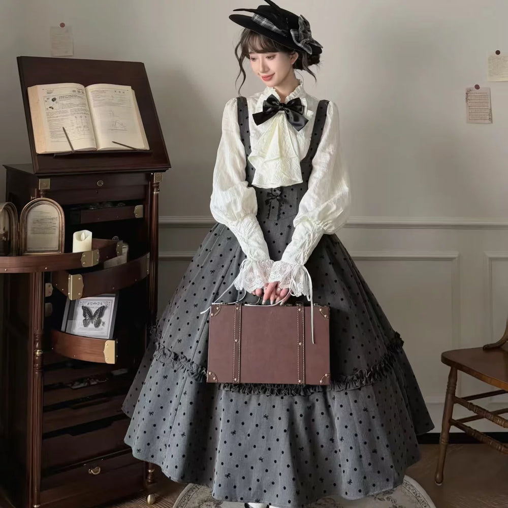 Charcoal-grey dotted Lolita skirt and white bow blouse styled on a model