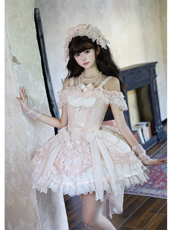 Pink-and-white JSK dress with layered ruffles, floral details and a large train worn by a model.