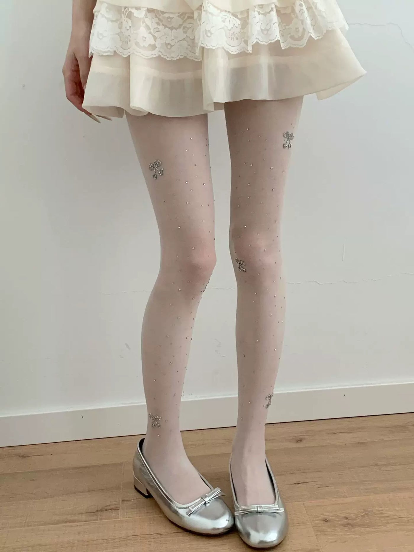 Modelled light tights with scattered rhinestones and small cherry motifs
