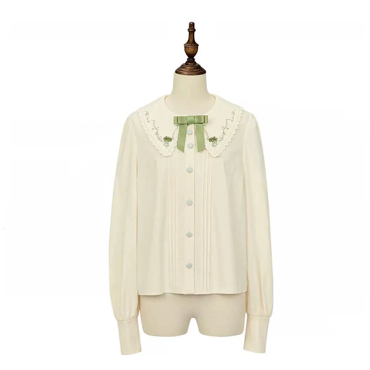 Milky-white pointed-collar Lolita blouse with a purple bow on a mannequin.