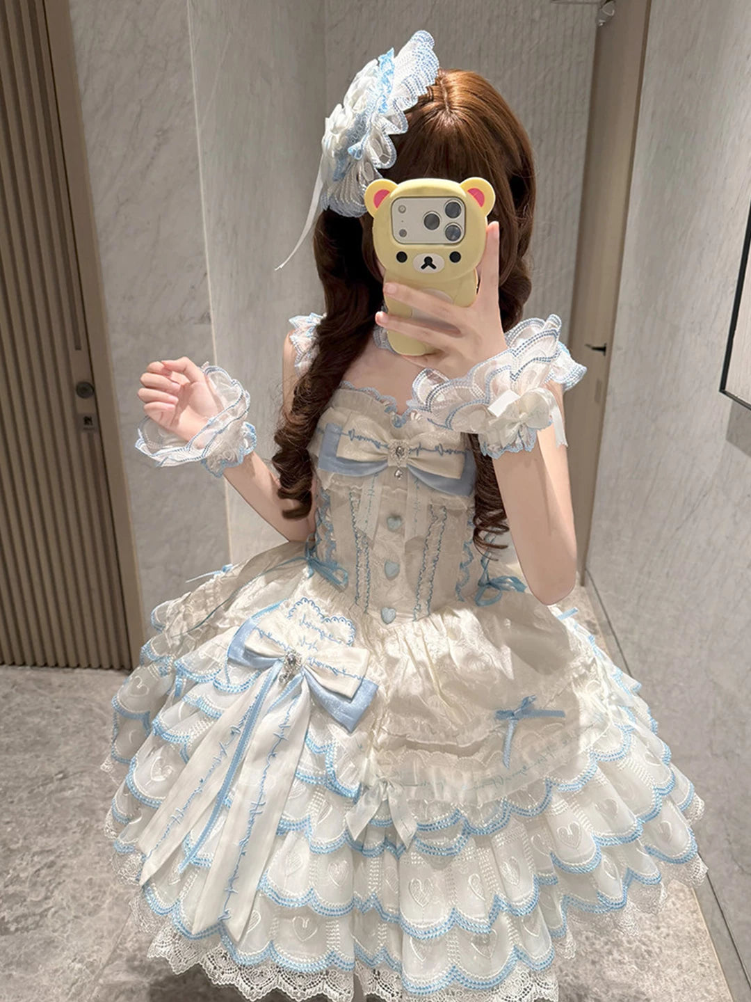 Back view of blue and white sweet lolita JSK showing corset lacing and tiered skirt