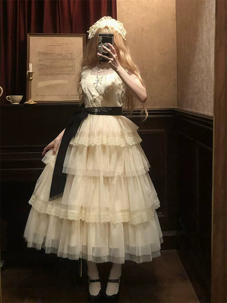 Creamy ivory tiered OP dress with lace-edged skirt layers and black waist belt
